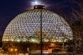 Night scene of the Desert Dome, with the full moon riding on the top, at Henry Doorly Zoo Omaha Nebraska.