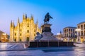 Night scene of Duomo cathedral in Milano viewed behind statue of king Vittorio Emanuele II