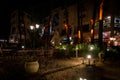 Night scene of an elegant outdoor bar illuminated by small lamps among the trees and plants Royalty Free Stock Photo