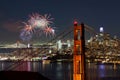 a night scene featuring fireworks in the sky over a bridge