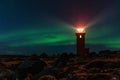 A Night Scene With The Green Lights Shining On Top Of A Lighthouse