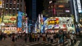 Night scene from Kabukicho district in Shinjuku with bright lights and people walking, Tokyo, Japan