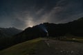 Night scene. A man walks in the mountains at night with a headlamp Royalty Free Stock Photo
