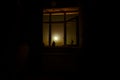 Night scene of moon seen through the window from dark room. Royalty Free Stock Photo