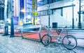 Night scene with parked bicycle and blurred speeding car in the Royalty Free Stock Photo