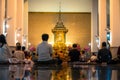 Night scene of people meditating in the temple. Wat Pathum Wanaram temple.