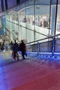 Night scene with people on a staircase near a shopping mall, Beijing, China