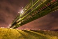 Night scene with pipeline overpass construction on a dike with sheep Royalty Free Stock Photo