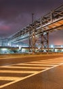 Night scene with pipeline overpass construction and train wagons Royalty Free Stock Photo