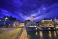 Night scene plus lightning in the sky of Basel on Mittlere Brucke stone bridge with Eisengasse road ahead, Switzerland