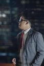 A night scene portrait of a business man looking at something on his left side inside an office. Royalty Free Stock Photo