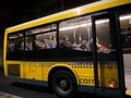 Night scene with Portuguese people - men women inside public transportation