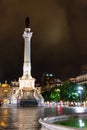 Night scene of Rossio Square, Lisbon, Portugal with one of its decorative fountains and the Column of Pedro IV