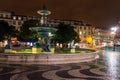 Night scene of Rossio Square, Lisbon, Portugal with one of its decorative fountains and the Column of Pedro IV