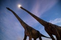 Night scene shot two big dinosaur stucco and the moonlight with clouds sky