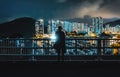 Night Scene of Silhouette of person in front of Modern Contemporary Skyscrapers at Marina with Piers and Yachts in Aberdeen, Hong Royalty Free Stock Photo