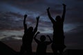 Night Scene With Silhouettes Of Joyful African Children Jumping In Their Courtyard With Hands Up Royalty Free Stock Photo