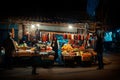 Night scene on the streets of Tbilisi, Georgia. Street sellers around corner selling traditional Georgian products with customers