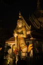 Night scene Thai Giant guardian at front entrance of the `Ordination Hall` in Wat Arun Ratchawararam. Royalty Free Stock Photo