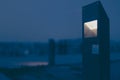 Night scene of a trendy architecturally designed light in the foreground