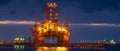 Night seaport, container terminal and oil rig Royalty Free Stock Photo