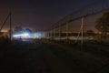 Night, security patrol car emerge from the bend of the trail Royalty Free Stock Photo