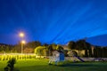 Night shining clouds over the wooden choldren house and a garden playground. Poland