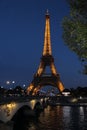 Night shoot of the Eiffel Tower with lights on, bridge above river