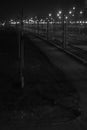 Night shooting of the crossing on the railway tracks, the bridging of the roads at the station flickers in the lights. Royalty Free Stock Photo