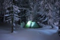 Night shot camping, long exposure, sleeping in the snow outside. Night bivouac in the mountains. Christmas time. Royalty Free Stock Photo
