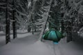 Night shot camping, long exposure, sleeping in the snow outside. Night bivouac in the mountains. Christmas time. Royalty Free Stock Photo