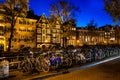 Night shot of the city, many bicycles on the bridge on Amsterdam canal, Netherlands Royalty Free Stock Photo