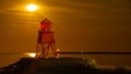 Night shot features a Herd Groyne Lighthouse situated on the edge of the water Royalty Free Stock Photo