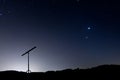 Night shot with a silhouette of a telescope