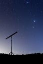 Night shot with a silhouette of a telescope