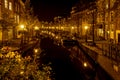 A night shot from the Sint Jansbrug on the Oude Rijn with numerous boats and illuminated old canal-side houses, Leiden, the Nether Royalty Free Stock Photo