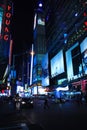 Night shot street skyscrapers neon signs New York