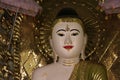 Night shot of stucco buddha statue decorated in golden be enshrined inside the arch at Shwedagon Pagoda, Yangon