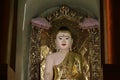 Night shot of stucco buddha statue decorated in golden be enshrined inside the arch at Shwedagon Pagoda, Yangon