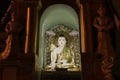 Night shot of stucco buddha statue decorated in golden be enshrined inside the arch at Shwedagon Pagoda, Yangon