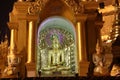 Night shot of stucco buddha statue decorated in golden be enshrined inside the arch at Shwedagon Pagoda, Yangon
