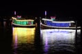 Night shot of two lighting decorated ships and reflex on the water. Royalty Free Stock Photo