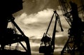 Night silhouettes of cargo cranes in the sea port black & white photo Royalty Free Stock Photo