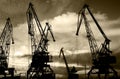 Night silhouettes of cargo cranes in the sea port black & white photo Royalty Free Stock Photo