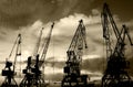 Night silhouettes of cargo cranes in the sea port black & white photo Royalty Free Stock Photo