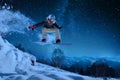 Night skating girl is jumping with snowboard under the starry sky and moonlight Royalty Free Stock Photo