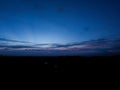 Night sky background, sunset wallpaper, nature photography, dark clouds in blue sky over the city Royalty Free Stock Photo