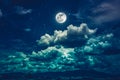 Night sky with bright full moon and dark cloud, serenity nature background Royalty Free Stock Photo