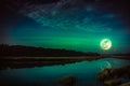 Night sky and bright full moon at riverside. Serenity nature background. Royalty Free Stock Photo