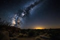 night sky filled with twinkling stars and the milky way over desert landscape Royalty Free Stock Photo